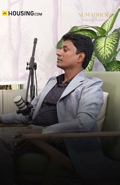 A Sumadhura spokesperson speaking into a studio microphone during a podcast